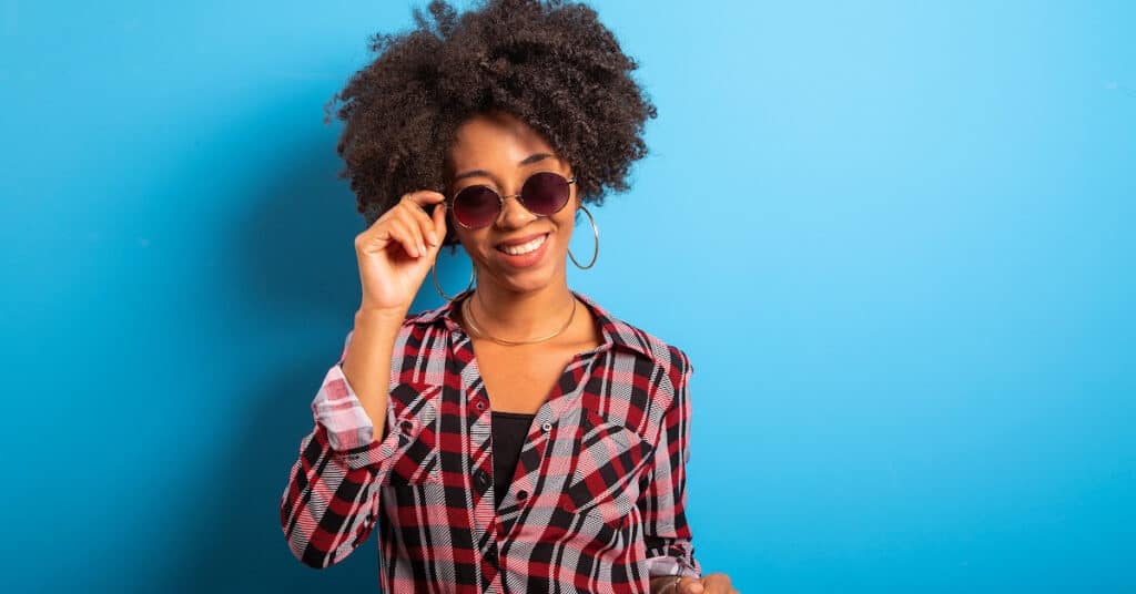 Black woman happy because she's learned how to keep her hair hydrated